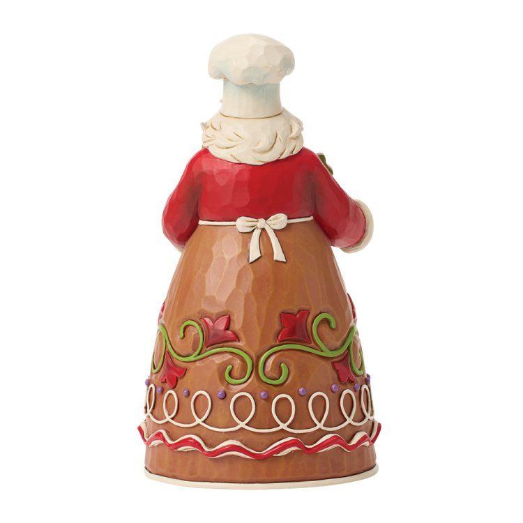 Peperkoekkokfiguurtje, achterkant gezien, rood en bruin, met witte koksmuts en schort.