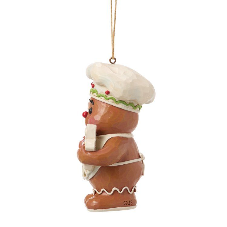Een peperkoekmannetje als ornament, met koksmuts en schort aan, en een recept in zijn hand.