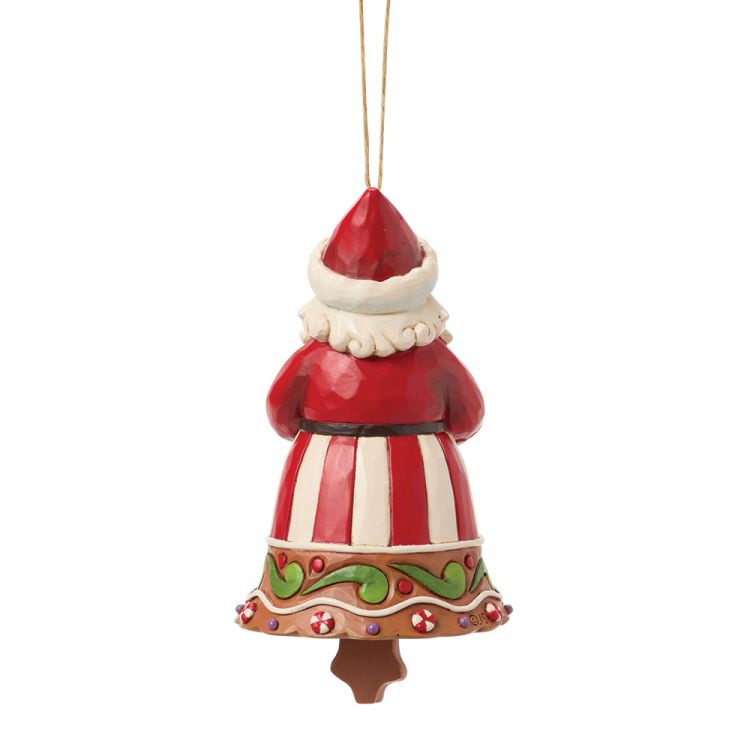Een kerstornament van de Kerstman met een bord koekjes in zijn hand, gekleed in een rood-wit gestreept pak.
