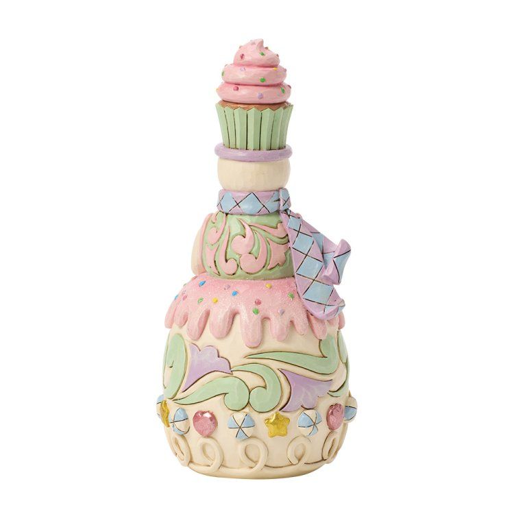 Sneeuwpop met tulbandcake en een cupcakehoedje op. Pastelkleuren, speelse stijl.