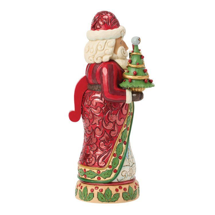 Een kerstmanfiguur met een kerstboom. Rood pak met ingewikkelde patronen, crèmekleurige baard en groene accenten.