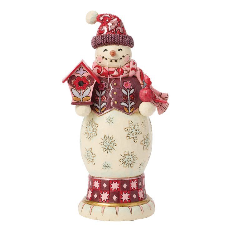 Sneeuwpopfiguurtje met rode muts, sjaal en vogelhuisje, versierd met bloemenpatronen.
