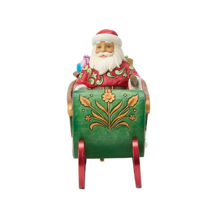 De Kerstman in een groene slee met rode sleeën, met cadeaus in zijn handen.