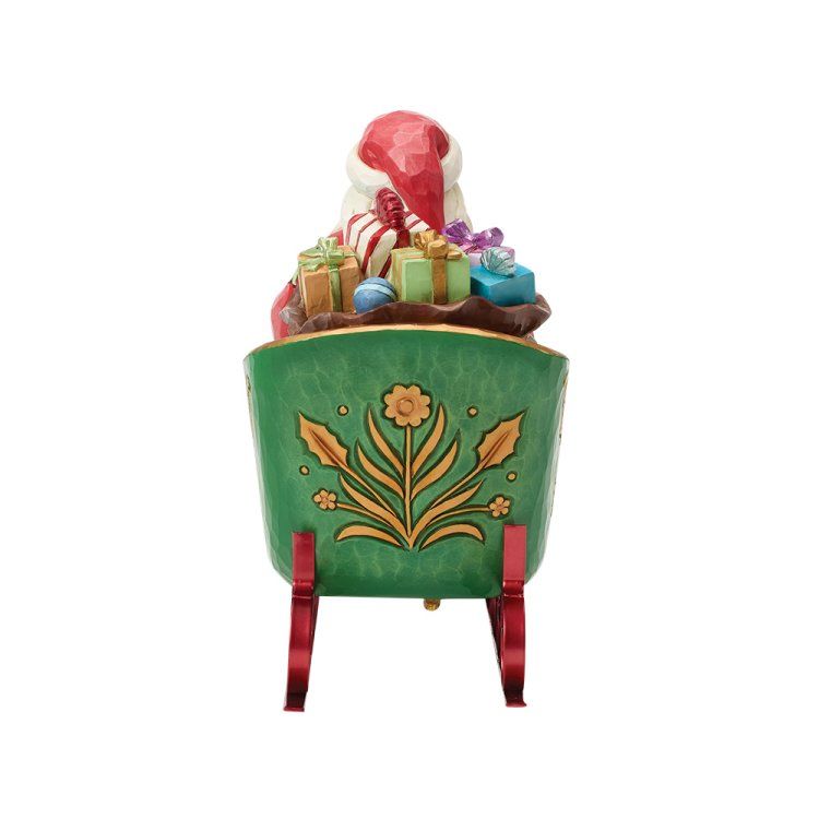 De kerstman in een groene slee volgeladen met cadeaus, rode lopers en een bloemmotief.