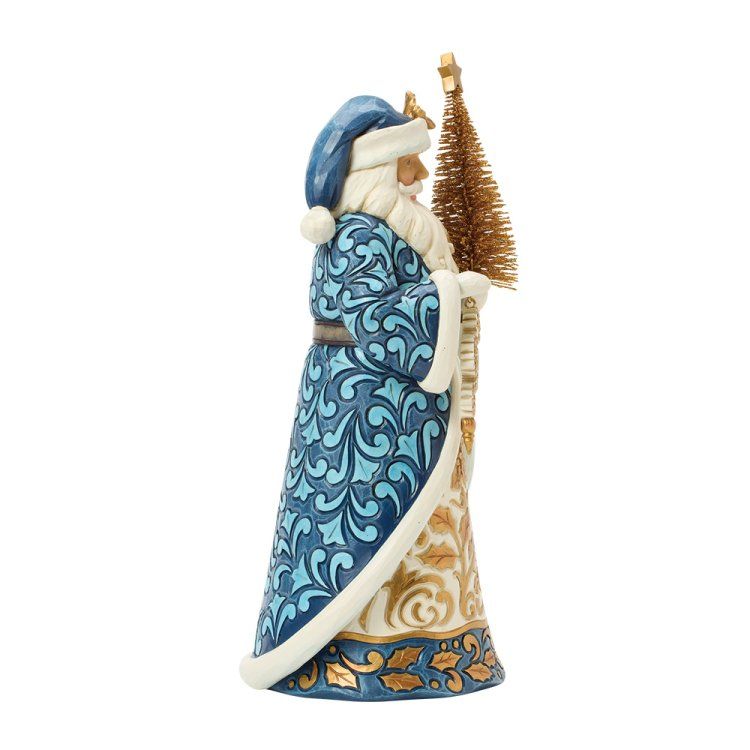 Een blauw-gouden kerstmanfiguurtje met een klein boompje.