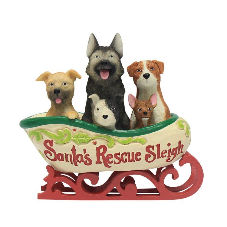 Kerstversiering: Honden in een slee. De slee is crèmekleurig en draagt ​​de tekst 