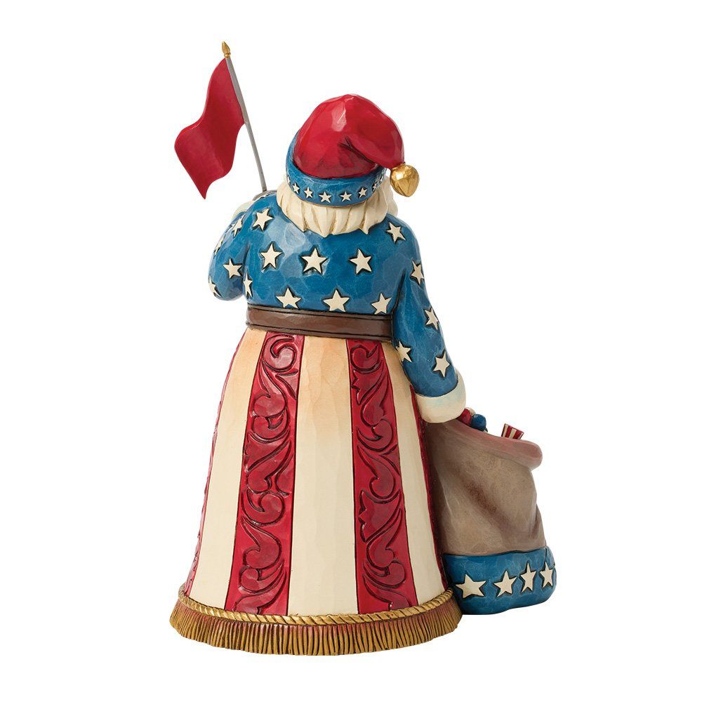 Een beeld van de Kerstman, rood, wit en blauw, met een vlag in zijn hand, en een cadeautas met de tekst 