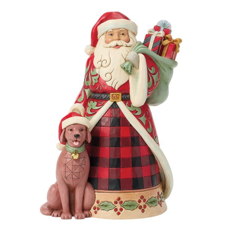 Een kerstmanfiguur met een hond die een kerstmuts draagt; gekleed in rode en groene kleding, met een zak vol cadeaus.