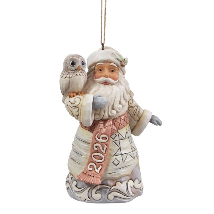 Een kerstmanfiguur met een uil op zijn schouder en een sjaal met