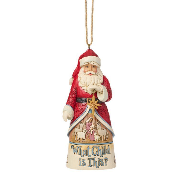 Een ornament van de Kerstman die een ster vasthoudt; onderaan is een kerststal afgebeeld.