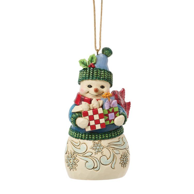 Een sneeuwpopfiguur met cadeautjes, een blauwe muts en een sjaal. Beige lijfje met sneeuwvlokkenmotief.