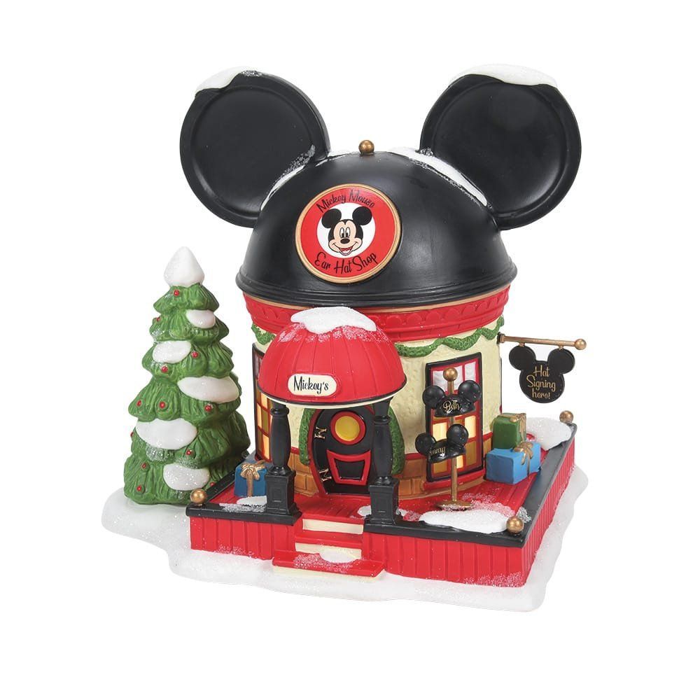 Een kerstwinkel in Disney-thema met Mickey Mouse-oren bovenop, bedekt met sneeuw en met rode en zwarte accenten.