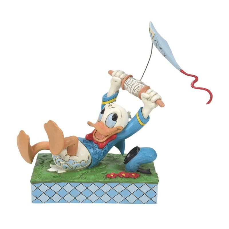 Een Donald Duck-figuurtje dat een vlieger oplaat, blauw, wit en rood, op groen gras met een geblokte ondergrond.