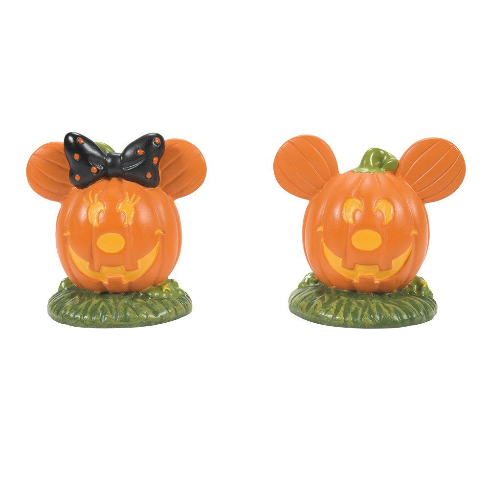 Uitgeholde pompoenfiguurtjes van Minnie en Mickey Mouse met jack-o'-lanterngezichten, geplaatst op het gras.