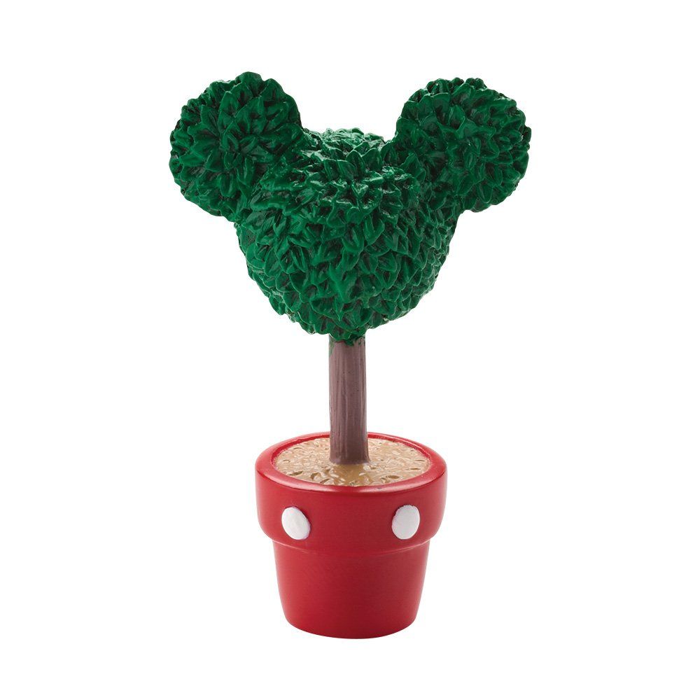 Een topiary in de vorm van Mickey Mouse in een rode pot met witte stippen. Groen blad, bruine stam.