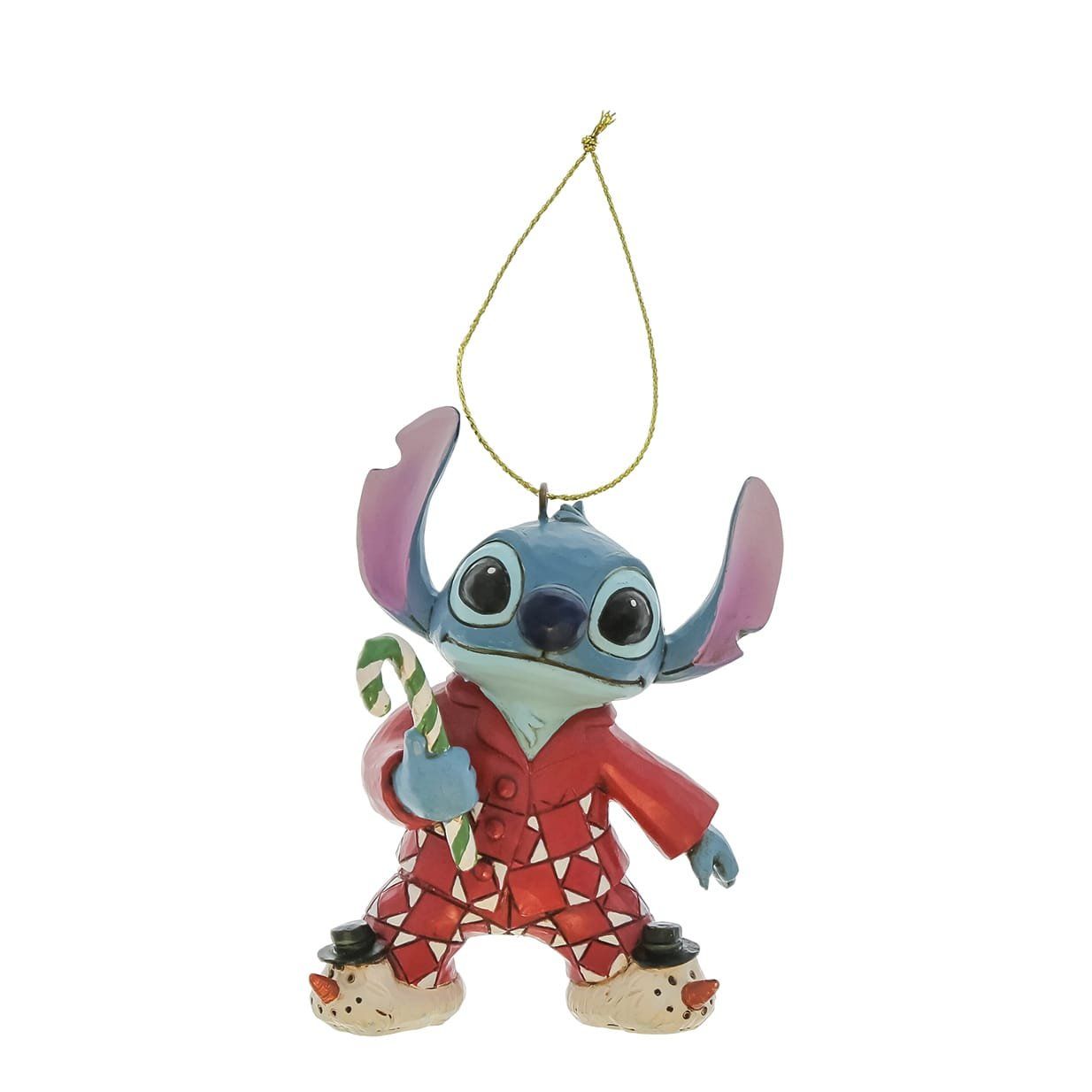 Stitch, gekleed in een rode pyjama en sneeuwpopslippers, houdt een zuurstok vast, een kerstversiering.
