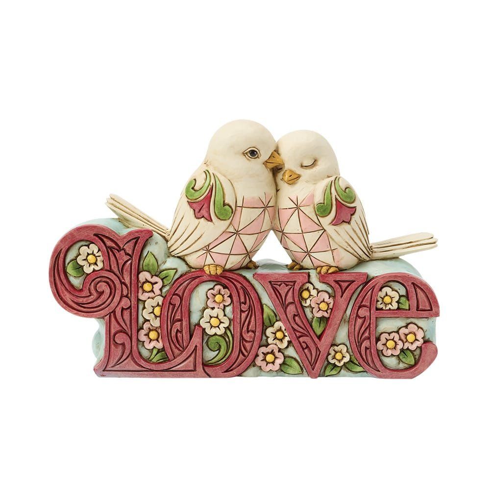 Twee ivoren vogels zitten op een decoratief