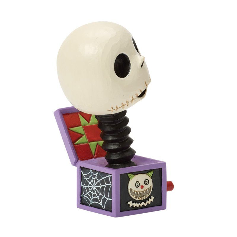 Jack Skellington springpopfiguurtje met skeletkop, zwarte veerhals, paarse doos en eng gezicht.