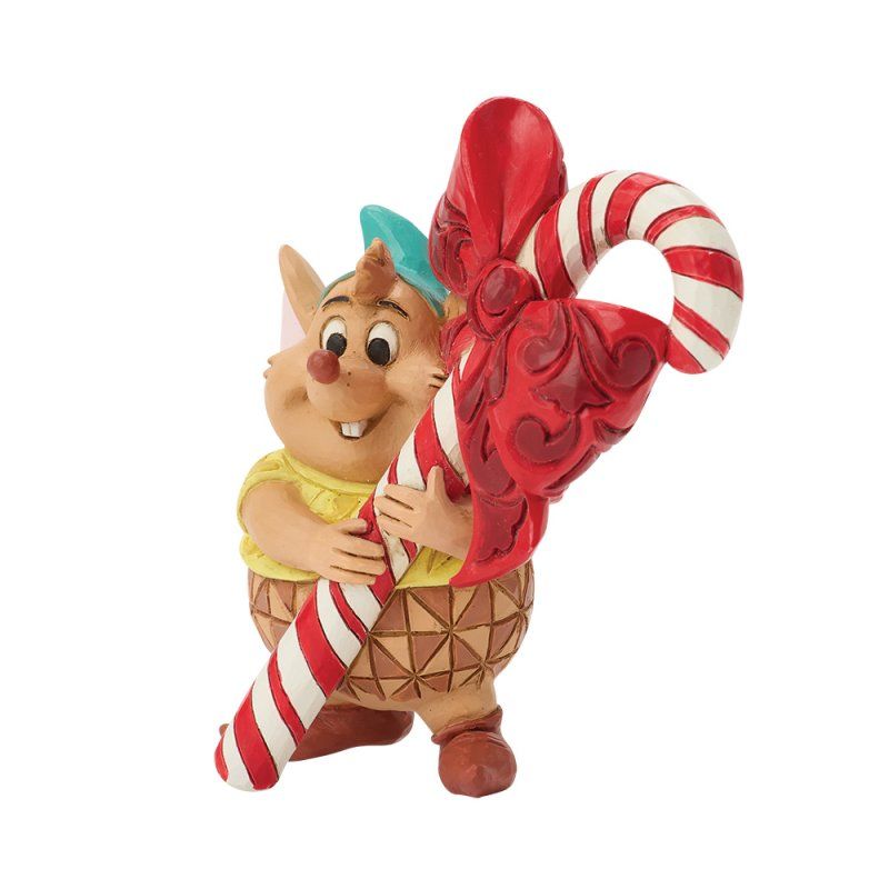 Figuurtje van Chip die een grote, met hartjes versierde zuurstok vasthoudt. Hij draagt ​​een geel shirt en heeft een vrolijke uitdrukking.