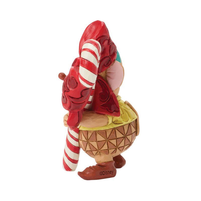 Figuurtje van een persoon met een zuurstok en hoed, een gebruinde huid en rode en witte details.