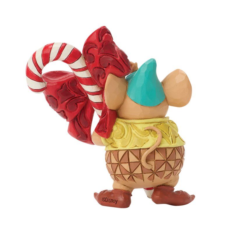 Figuurtje van een muis met een zuurstok in haar hand, gekleed in een turquoise hoedje, een geel vestje en een rokje met patroon.