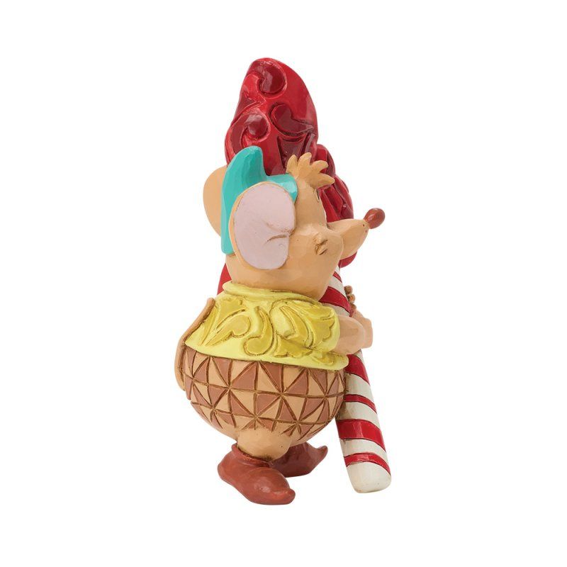 Figuurtje van een lachende cartoonmuis met een grote zuurstok en een rode strik.