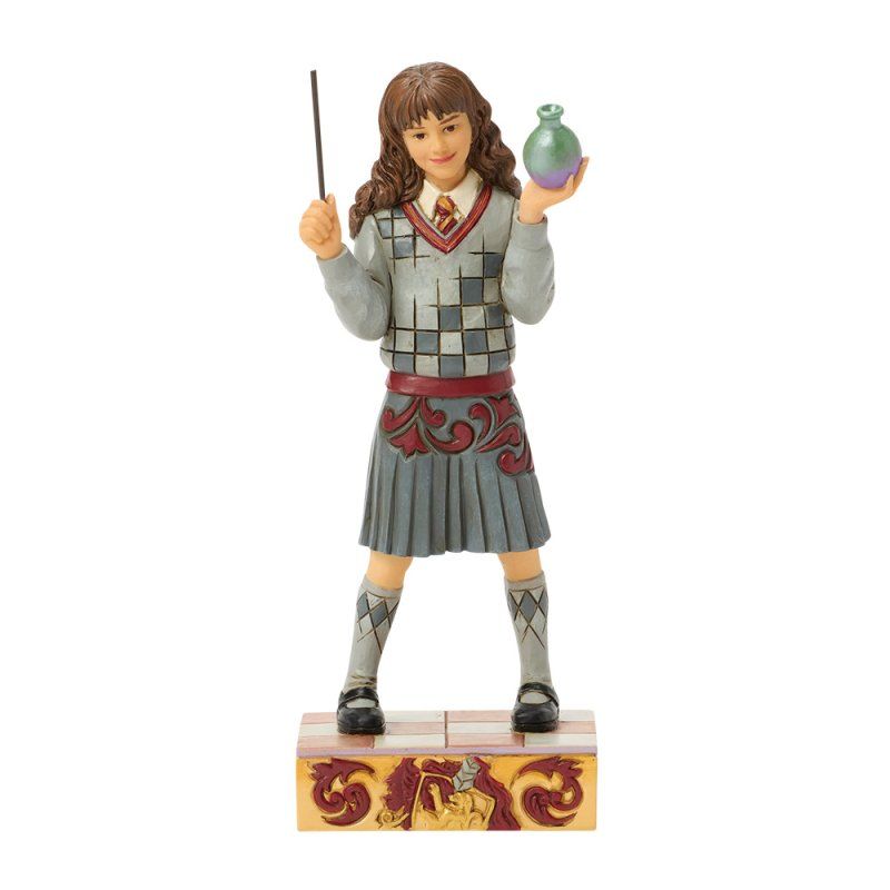 Standbeeld van Hermione Granger met een toverstaf en een toverdrank in haar hand, gekleed in een Griffoendor-uniform.