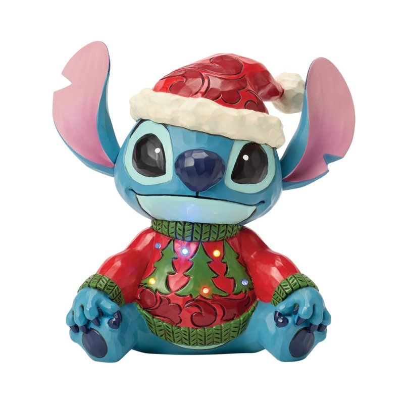 Een figuurtje van Stitch met een kerstmuts en een trui met kerstboommotief.