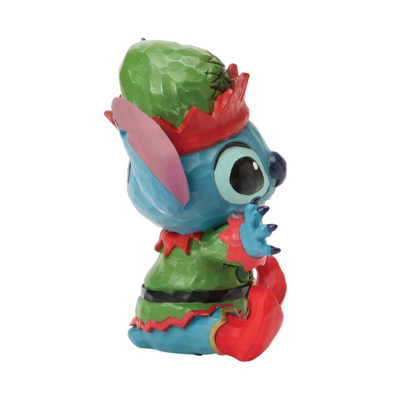Een Stitch-figuurtje verkleed als elf, met een blauwe huid en een groen-rode outfit.
