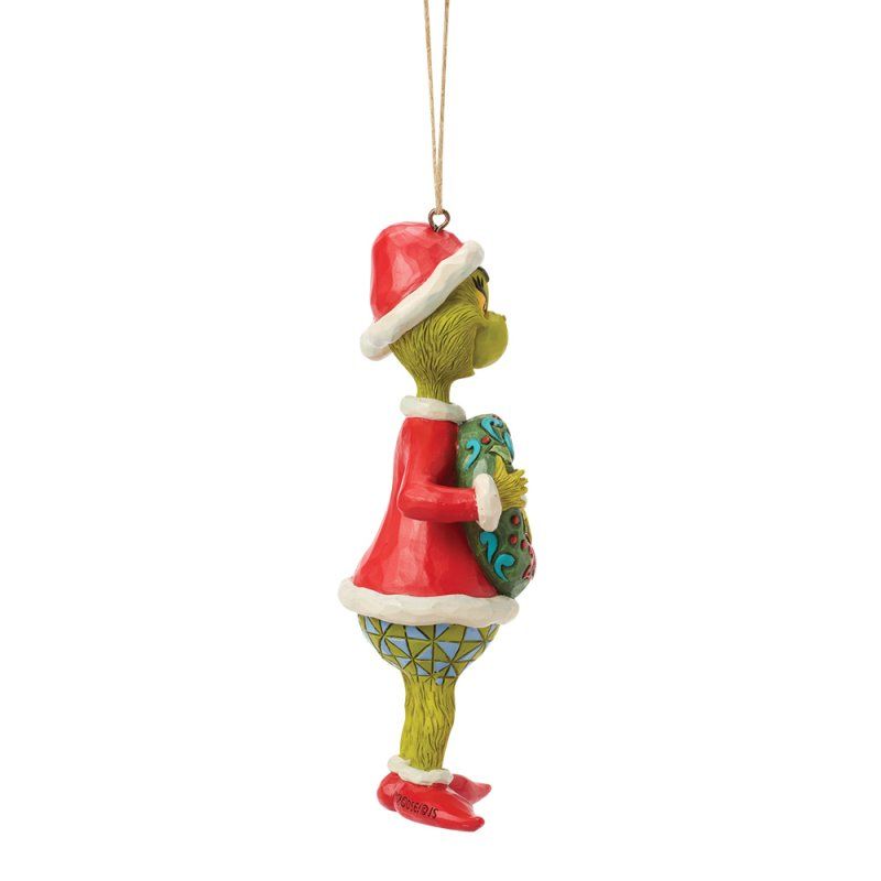 Kerstornament van de Grinch met een kerstmuts en een kerstkrans in zijn hand. Groen en rood van kleur.