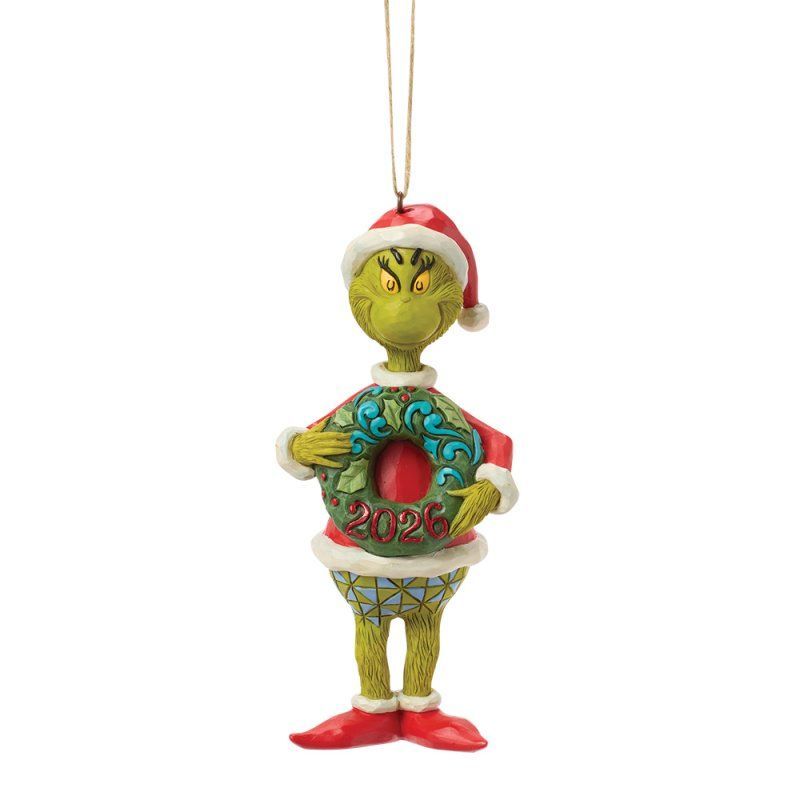 Kerstornament van de Grinch met een kerstmuts en een kerstkrans in zijn hand. Groen en rood van kleur.