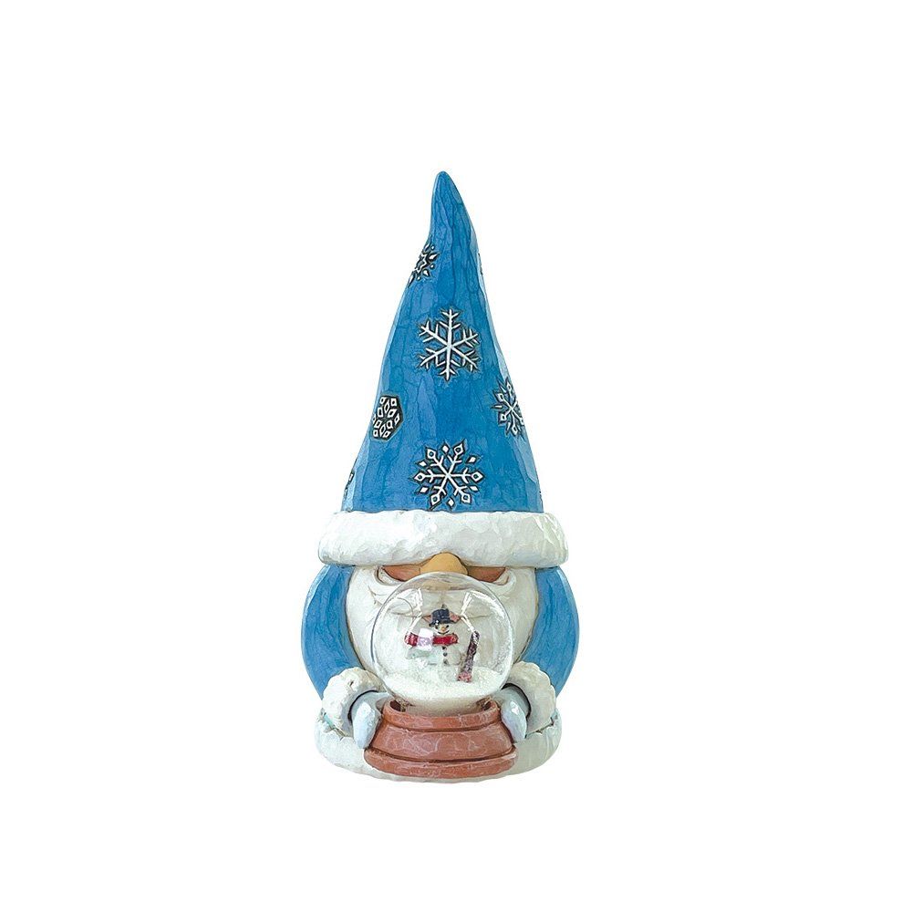 Een blauwe kabouter met een sneeuwbol in zijn hand, en een muts met sneeuwvlokkenpatroon op.