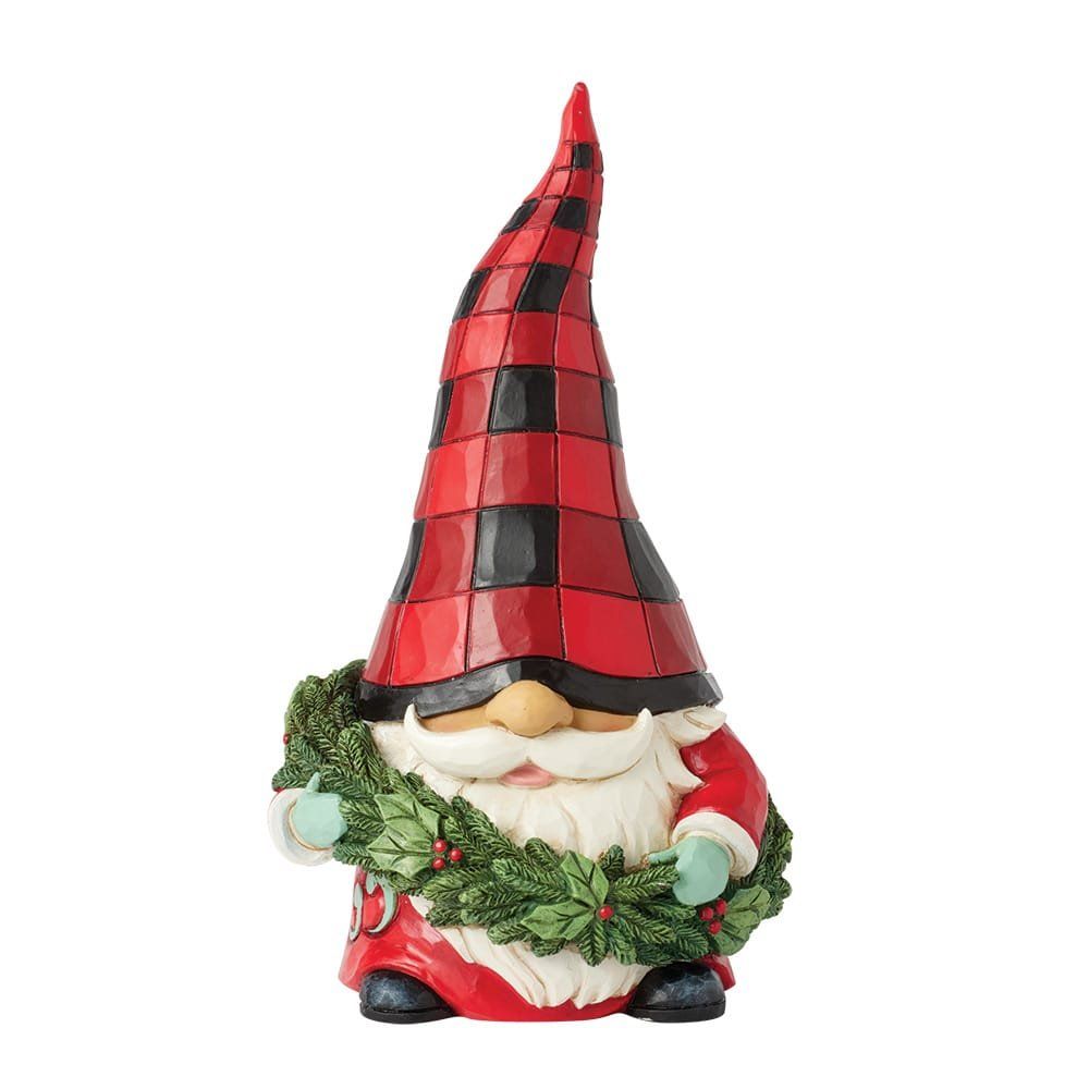 Kerstkabouterfiguurtje met een rood-zwart geruite muts, die een groene krans vasthoudt.