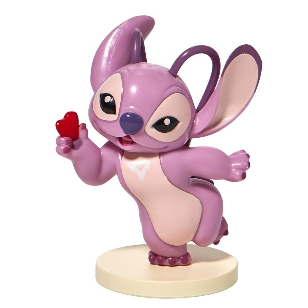 Figuurtje van Angel uit Lilo & Stitch, die een rood hartje vasthoudt, roze en paars met een crèmekleurige basis.