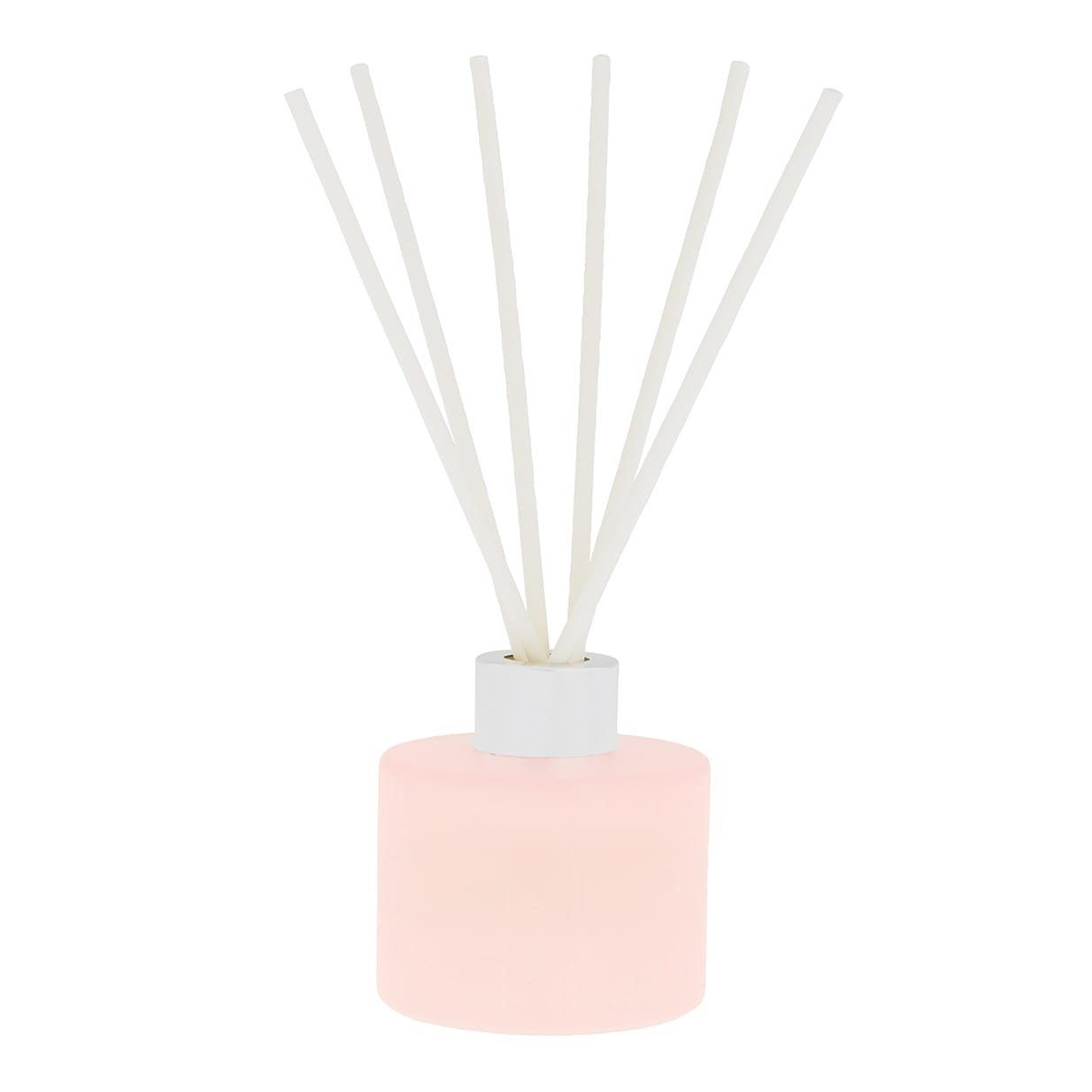 Roze etherische olie diffuser met witte rietjes; gouden letters: IRISI BOTANICS.