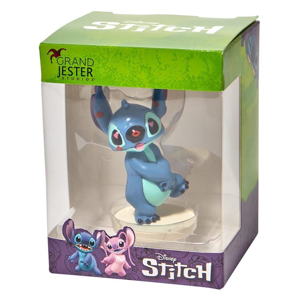 Stitch-figuurtje in doos; blauw buitenaards wezentje dat balanceert. Verpakking met Disney-logo.