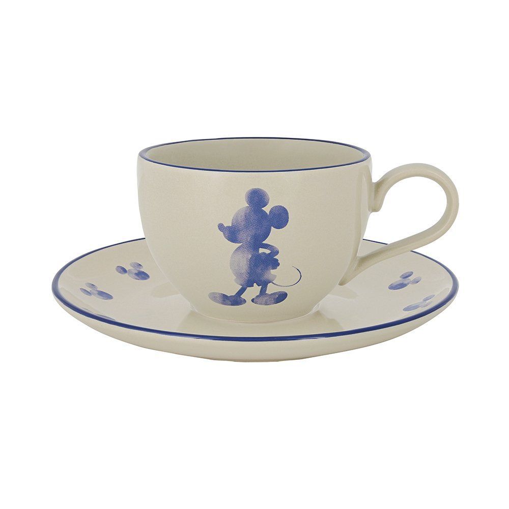 Crèmekleurig theekopje met schoteltje en blauwe Mickey Mouse-silhouet. Blauwe rand.