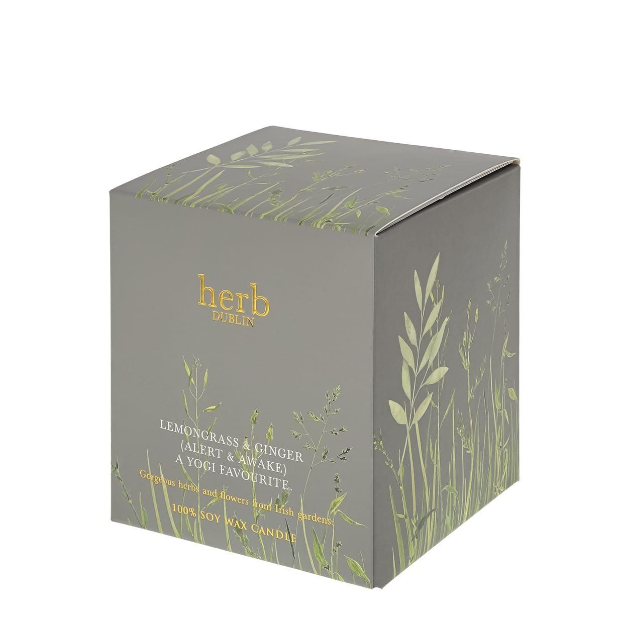 Grijze productdoos met gouden tekst en bloemenmotief, waarschijnlijk voor een geurkaars.