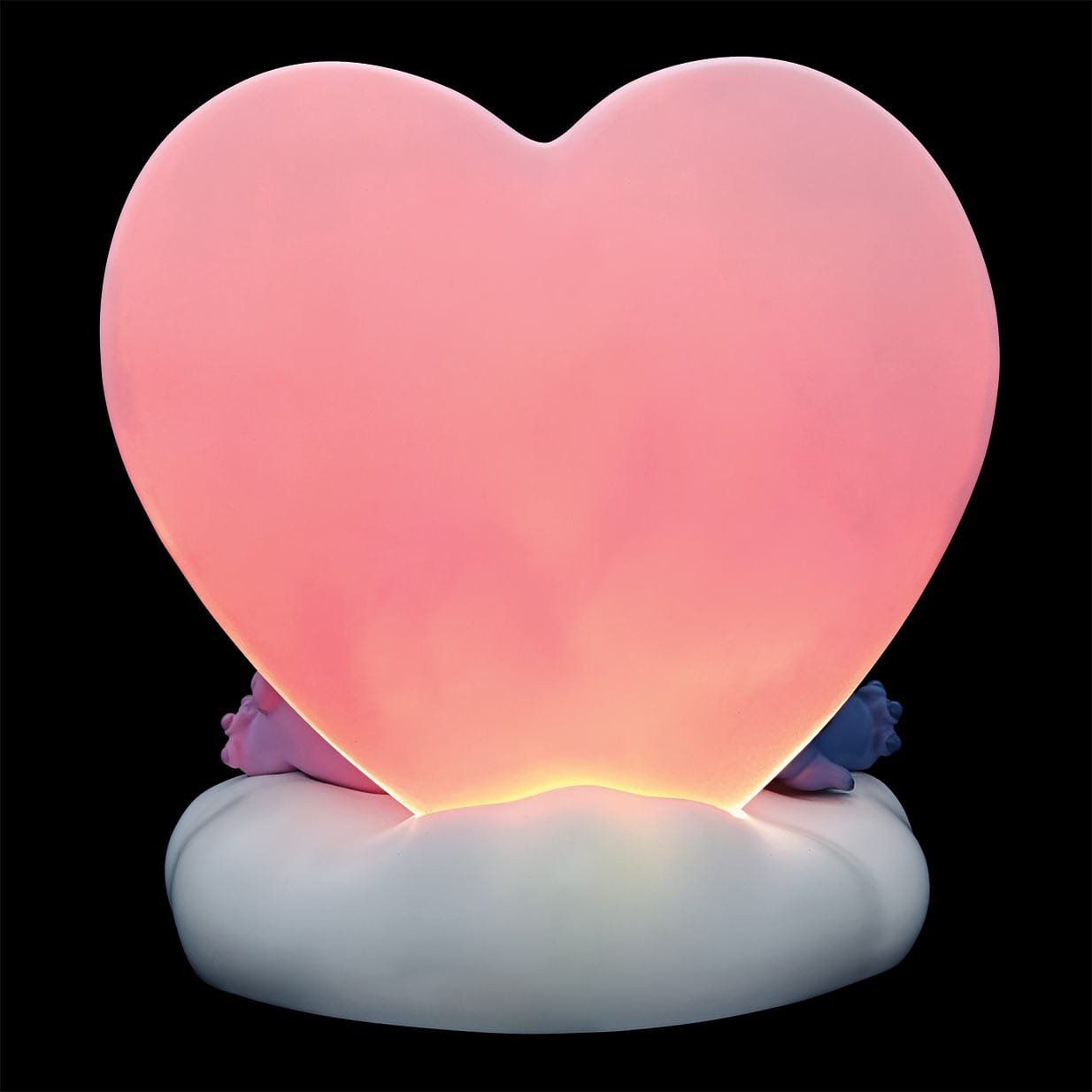 Roze hartvormig nachtlampje op een witte wolkvoet; geeft een zacht licht.