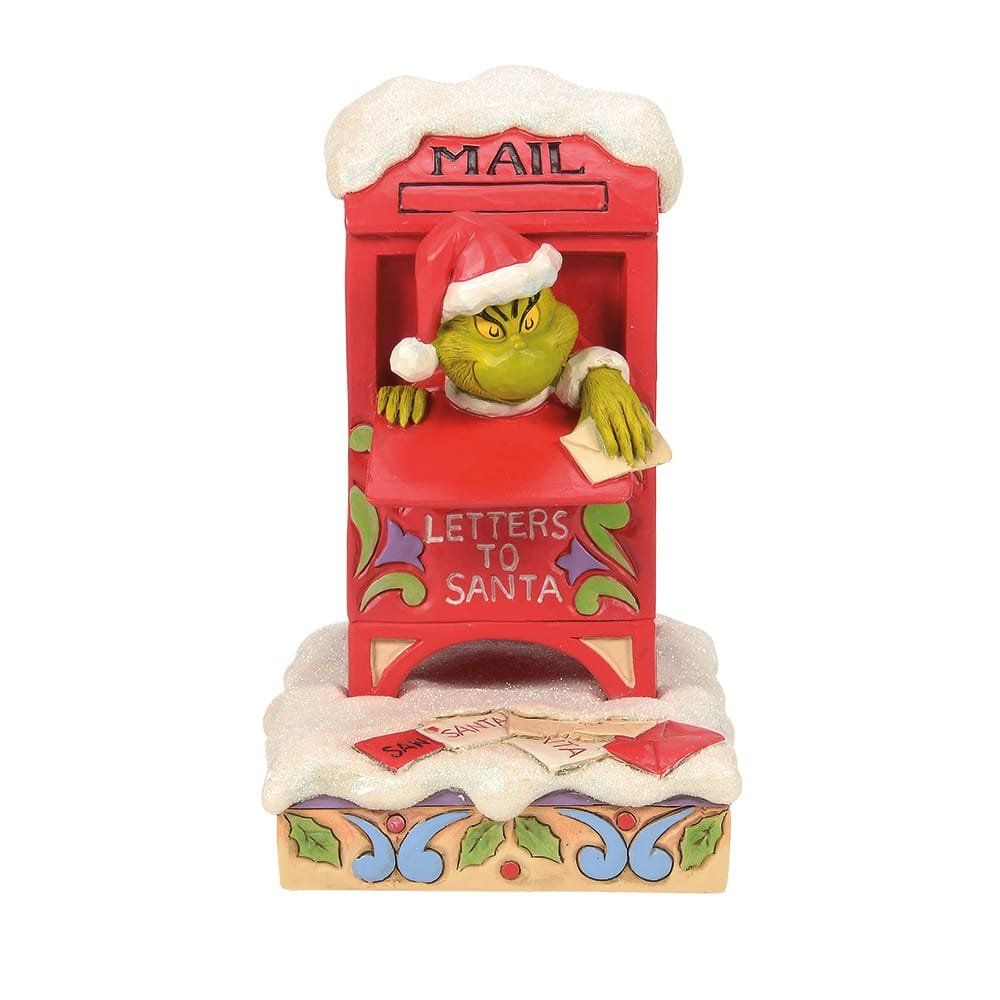 De Grinch met kerstmuts in een rode, met sneeuw bedekte brievenbus met de tekst