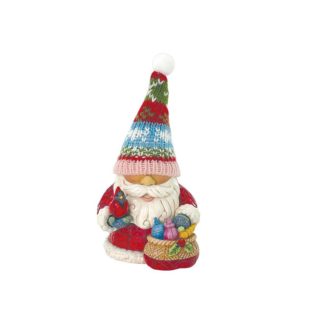 Kerstmanfiguur met gebreide muts en cadeautas.