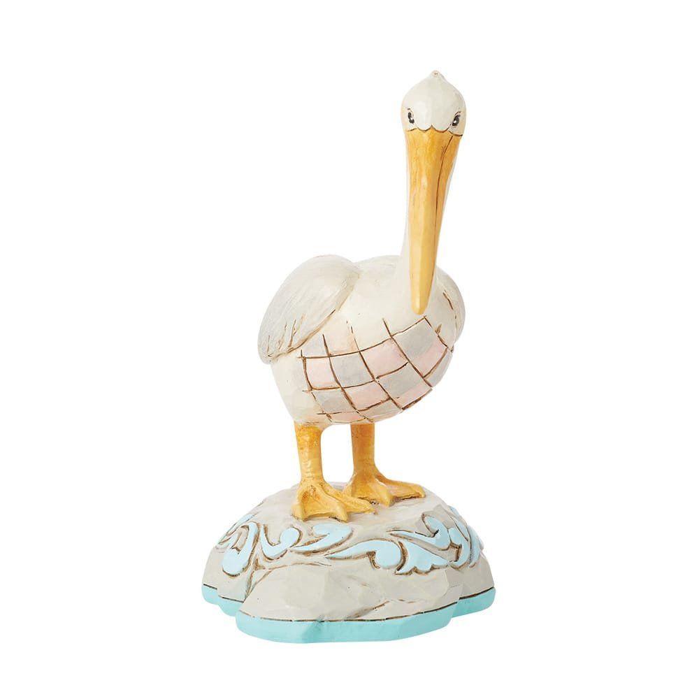 Wit-gele pelikaanfiguur op een decoratieve sokkel met blauwe accenten.