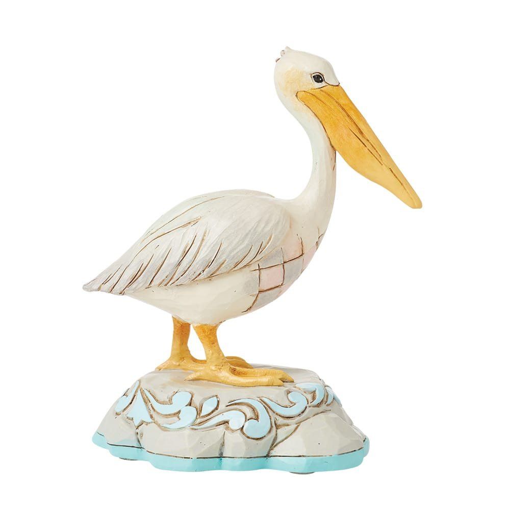 Wit-gele pelikaanfiguur op een decoratieve sokkel met blauwe accenten.