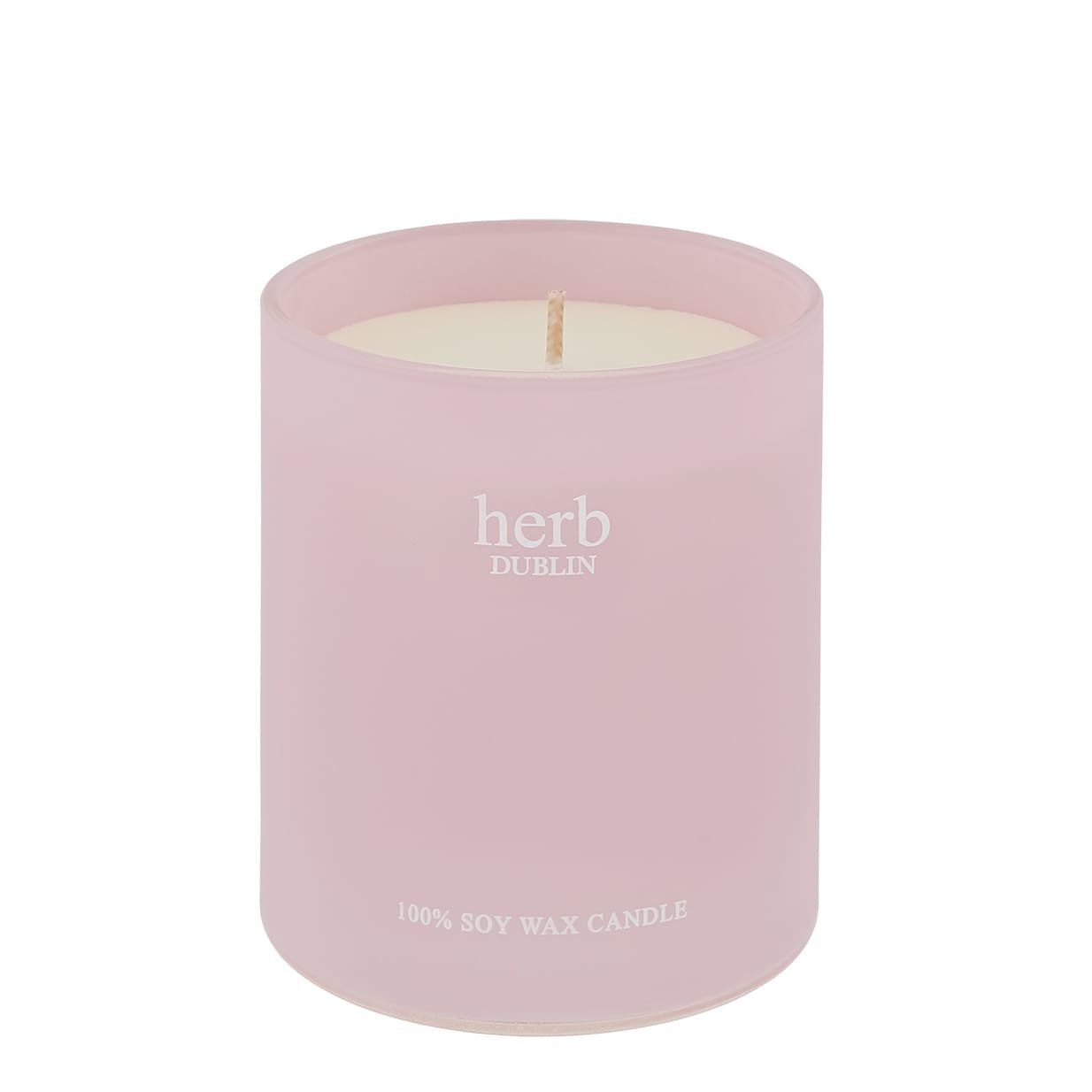 Roze kaars in een matglazen potje met een lont. Tekst: