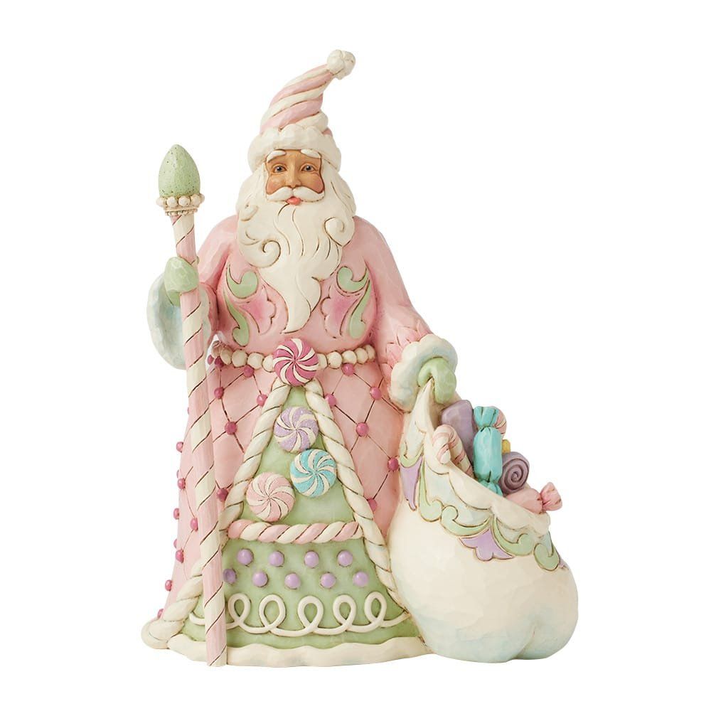 Roze en groene kerstmanfiguur met staf en zak snoep.