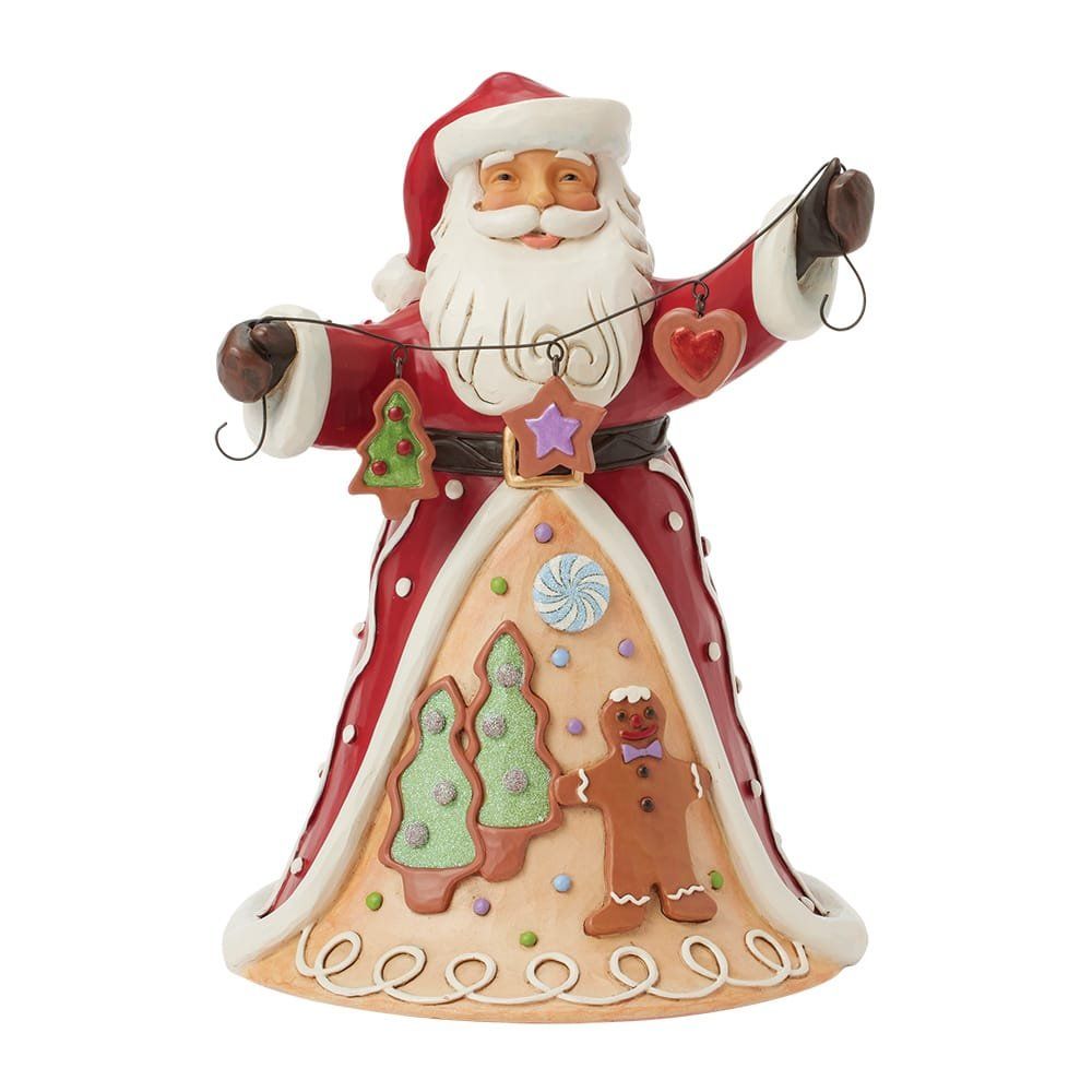 Een kerstmanfiguurtje met een slinger peperkoekversieringen. Rood en wit, met een lachend gezicht.