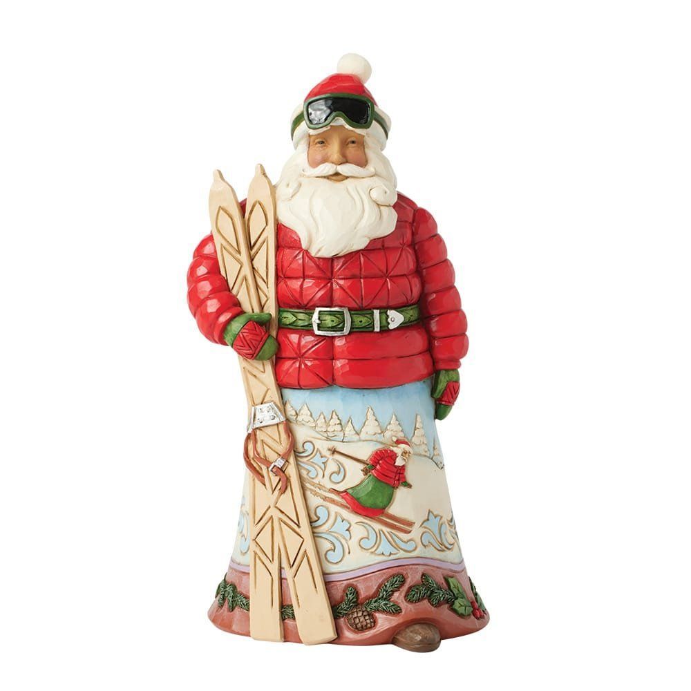 Skiënde kerstmanfiguur in rode gewatteerde jas, met ski's en skibril; rok beschilderd met een winterlandschap.