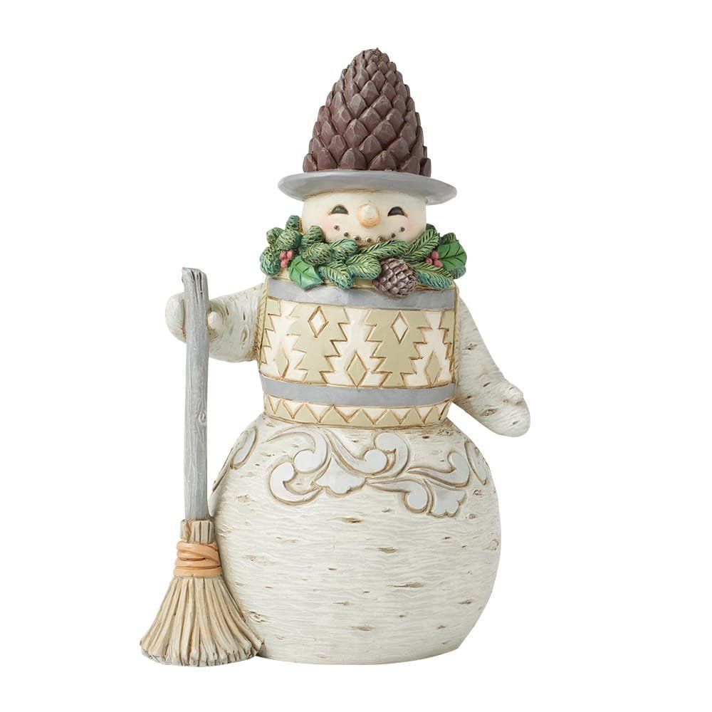 Een sneeuwpopfiguur met een dennenappelmuts op, een bezem en een decoratieve krans.