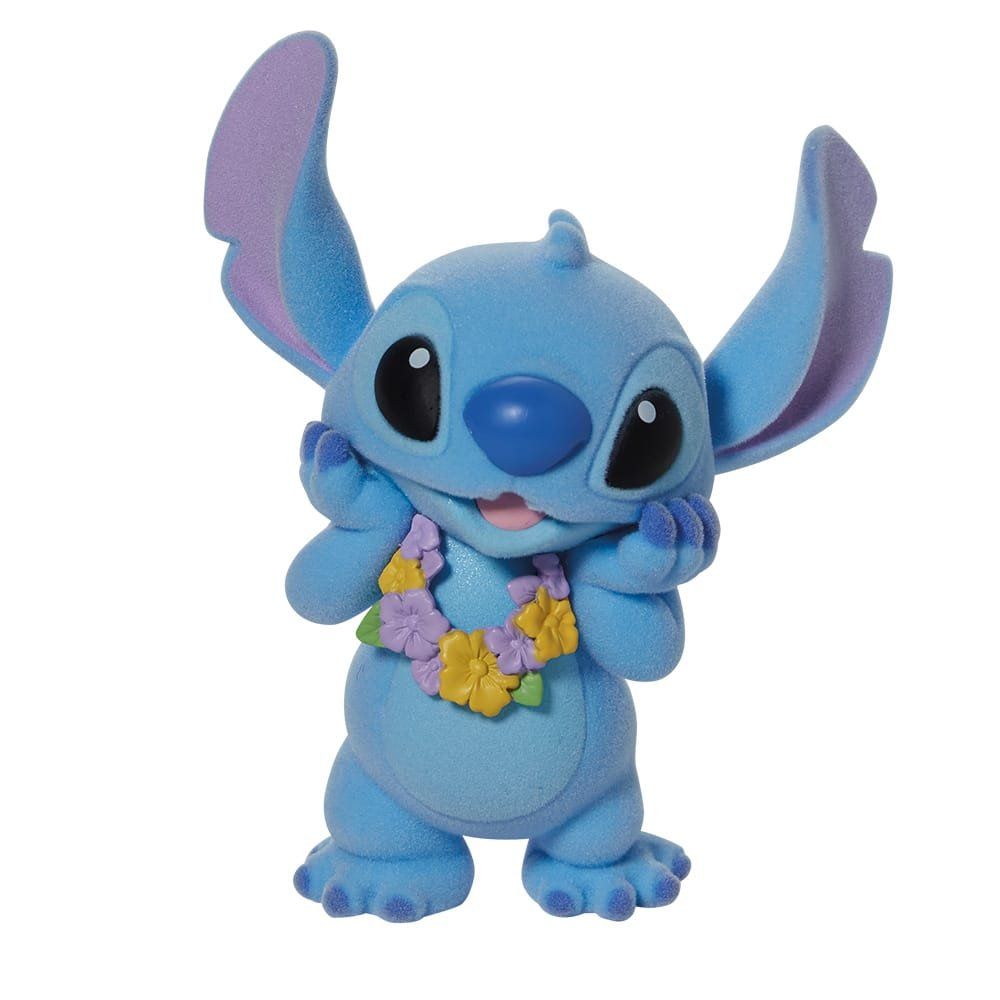 Een Stitch-figuurtje in blauw en paars, met een bloemenkrans om zijn nek en zijn handen bij zijn gezicht.