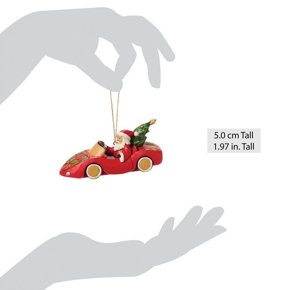 De kerstman in een rode auto, kerstboom, gouden slinger, handen omlijsten het ornament.